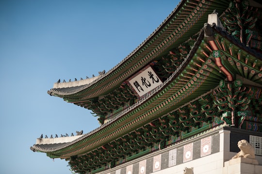 green and white temple at daytime in Gwanghwamun Gate South Korea