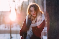 woman leaning on tree
