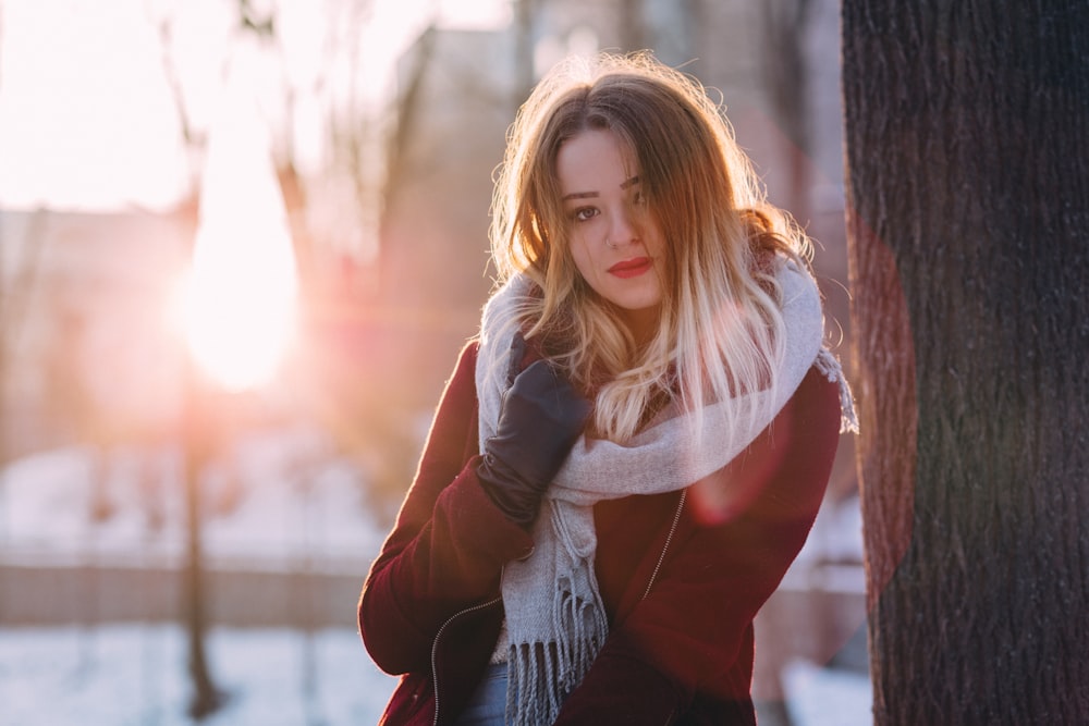 woman leaning on tree