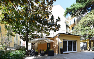 A cozy patio shaded by a sleek retractable awning on a sunny day.