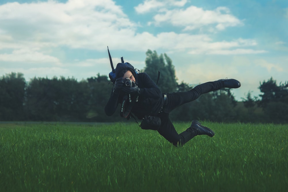 man taking photo while on mid air under white cloudy sky during daytime