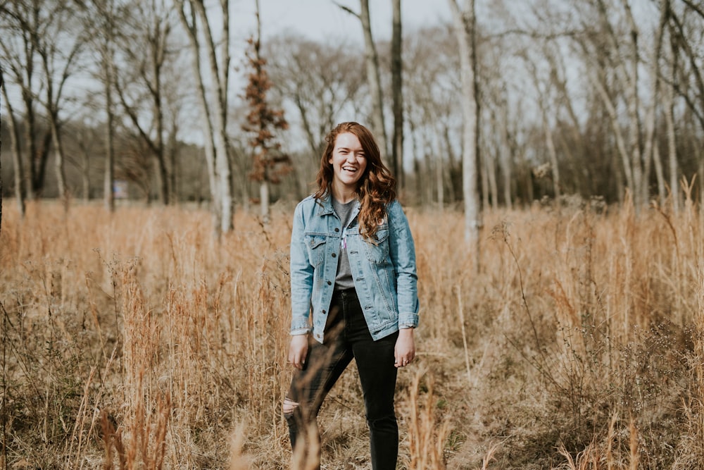 woman standing at forest while smiling
