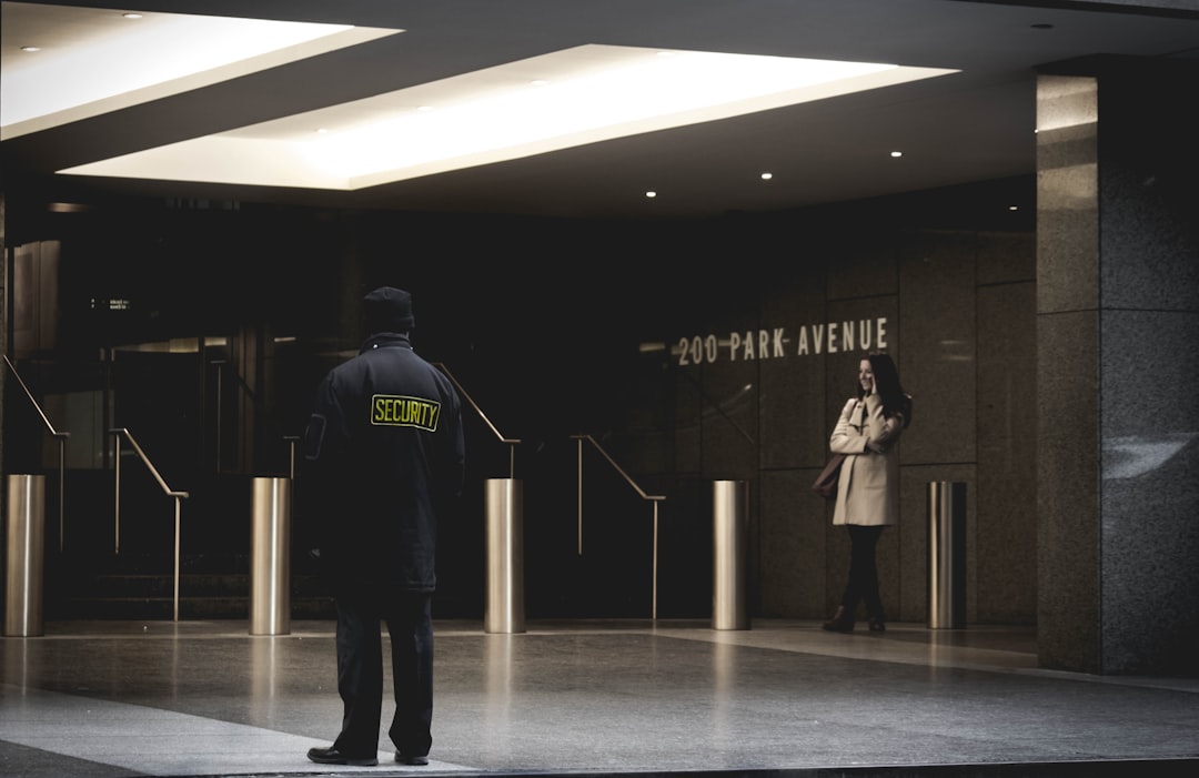 security guard standing on the gray floor,