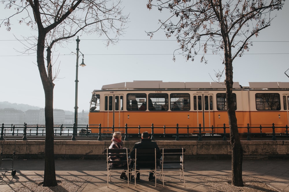 white and orange bus viewing mountain during daytime