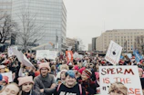 A peaceful march advocating for basic human rights taking place in a city street.