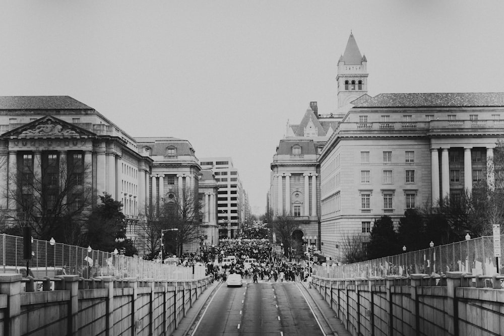 grayscale photo of people in city