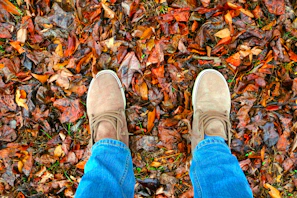 Casual tan loafers paired with rolled-up jeans and a cozy sweater outdoors
