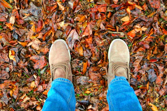 Casual tan loafers paired with rolled-up jeans and a cozy sweater outdoors