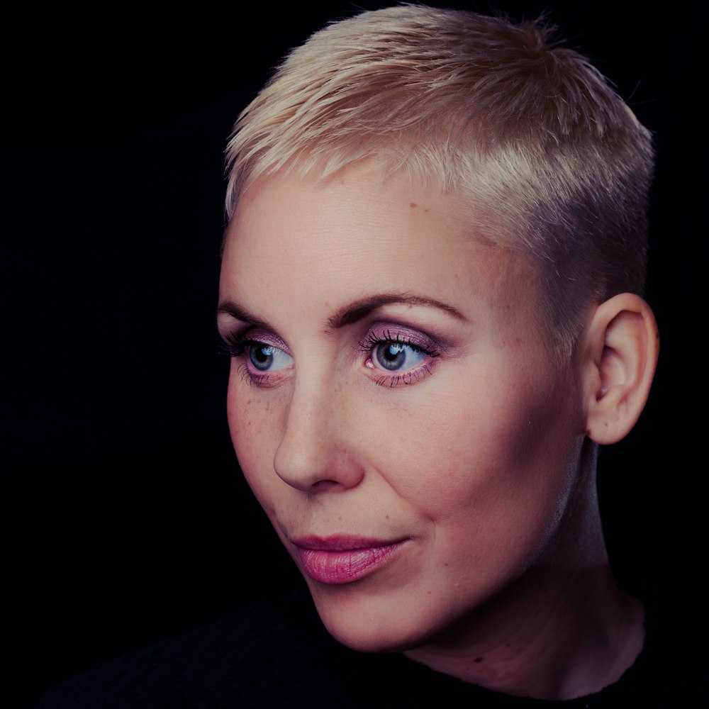 woman wearing crew-neck tee shirt with blonde short hair and pink lipstick