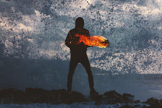 silhouette of person standing holding torch