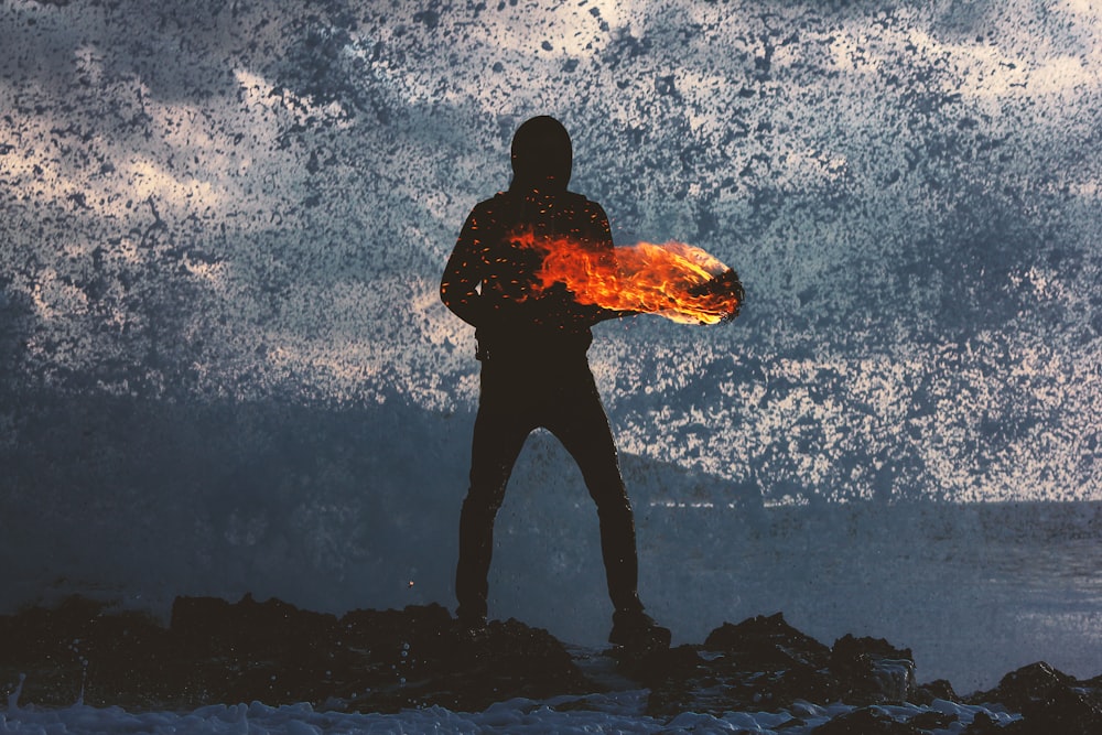 silhouette of person standing holding torch