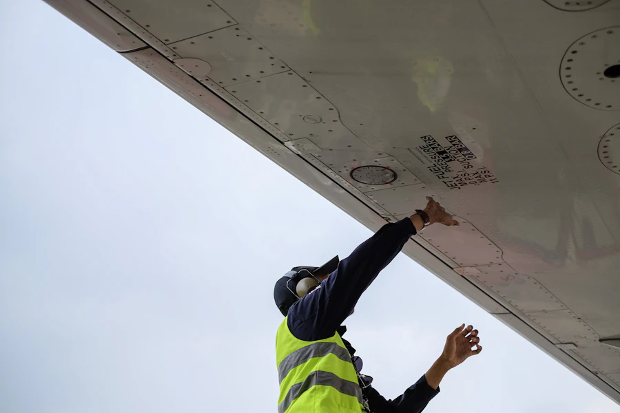 Aviation maintenance technician working under an aircraft