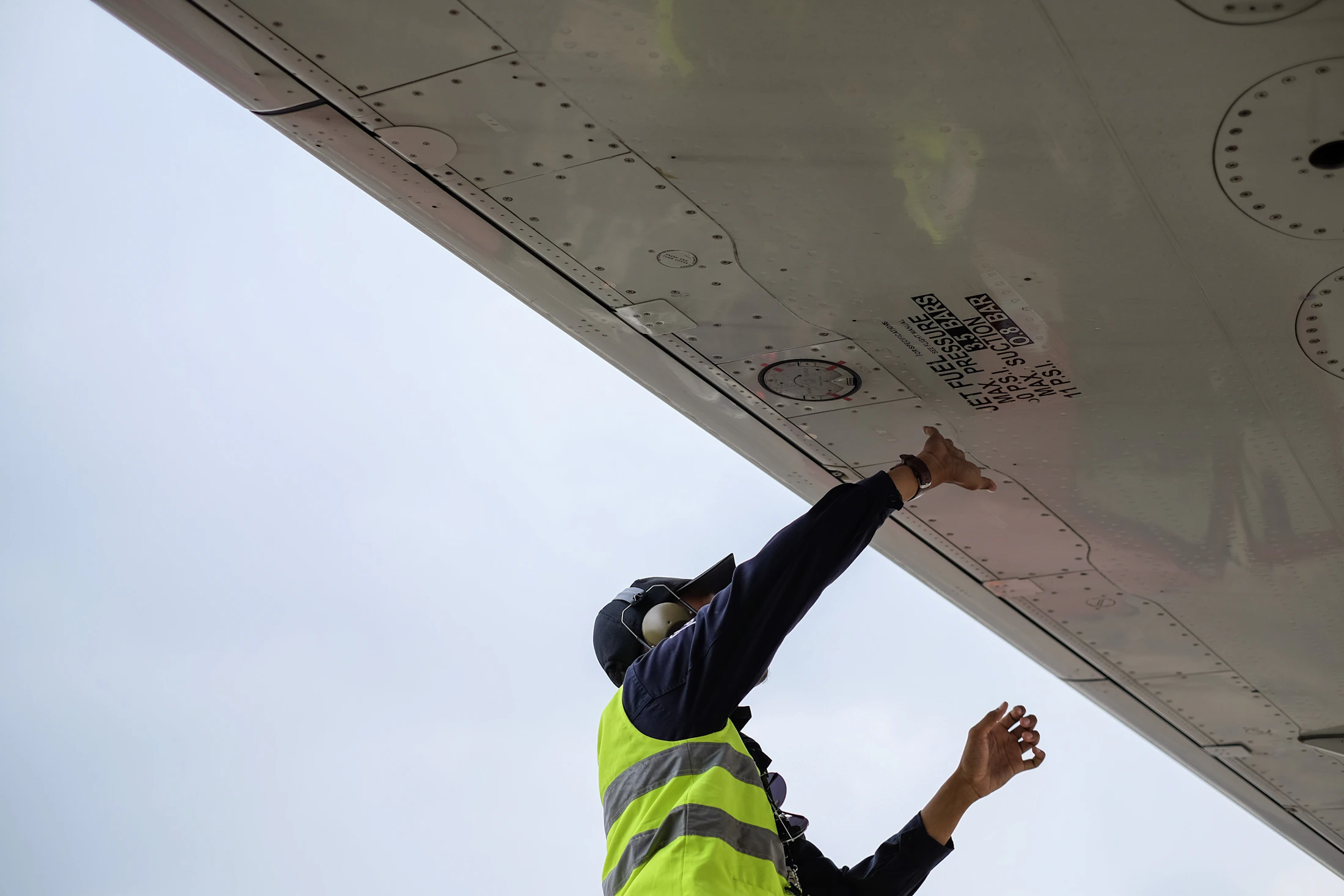 Aircraft maintenance specialist working beneath a structure