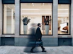 man in black suit jacket in walking gesture