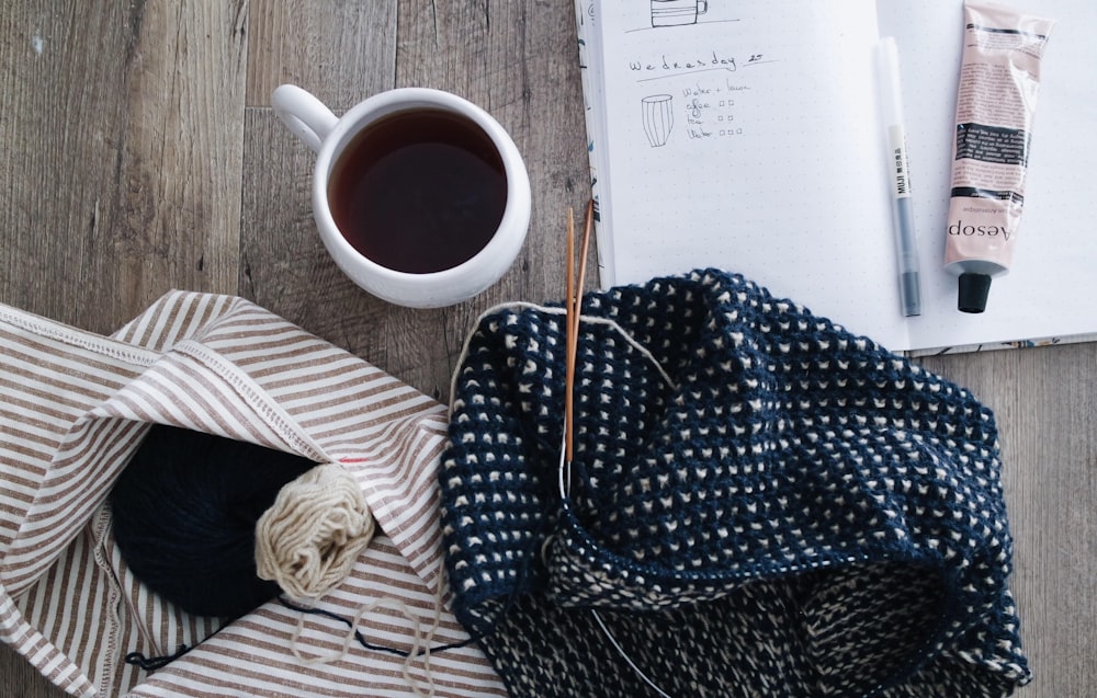 flat lay photography of white mug filled beverage