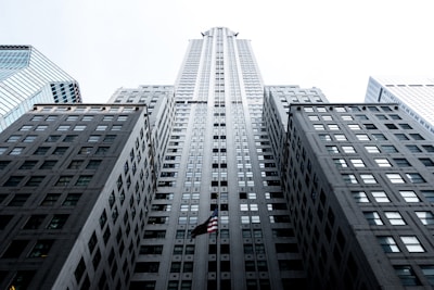 low angle photo of gray concrete high-rise building