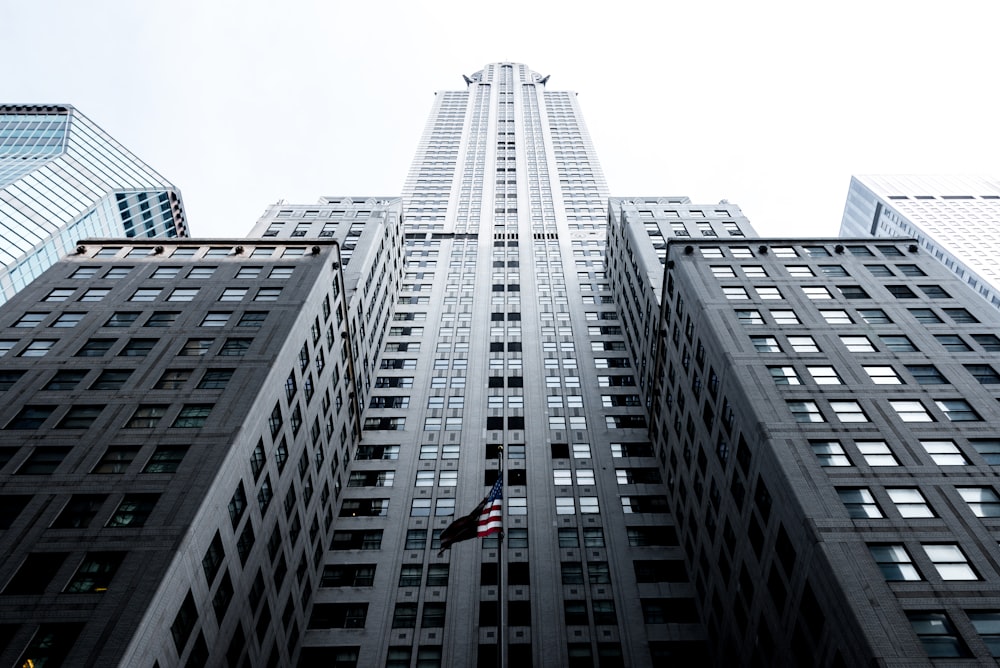 low angle photo of gray concrete high-rise building