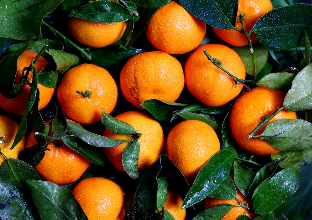 Washed oranges and green leaves freshly picked