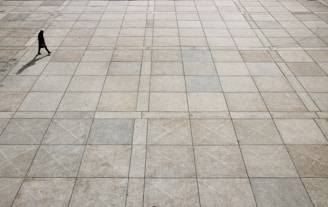 man walking on tiled ground at daytime