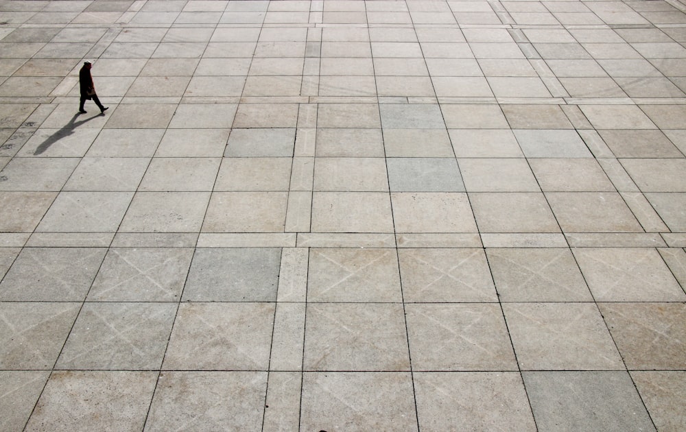 man walking on tiled ground at daytime