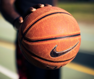 person holding brown Nike basketball