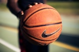 Close-up of hands gripping a sledsa llc basketball, highlighting texture.