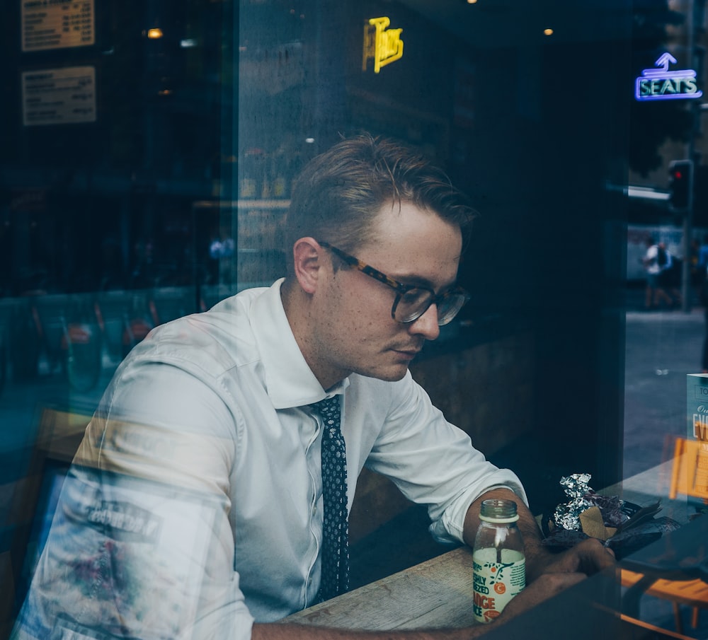 man wearing sunglasses inside cafe