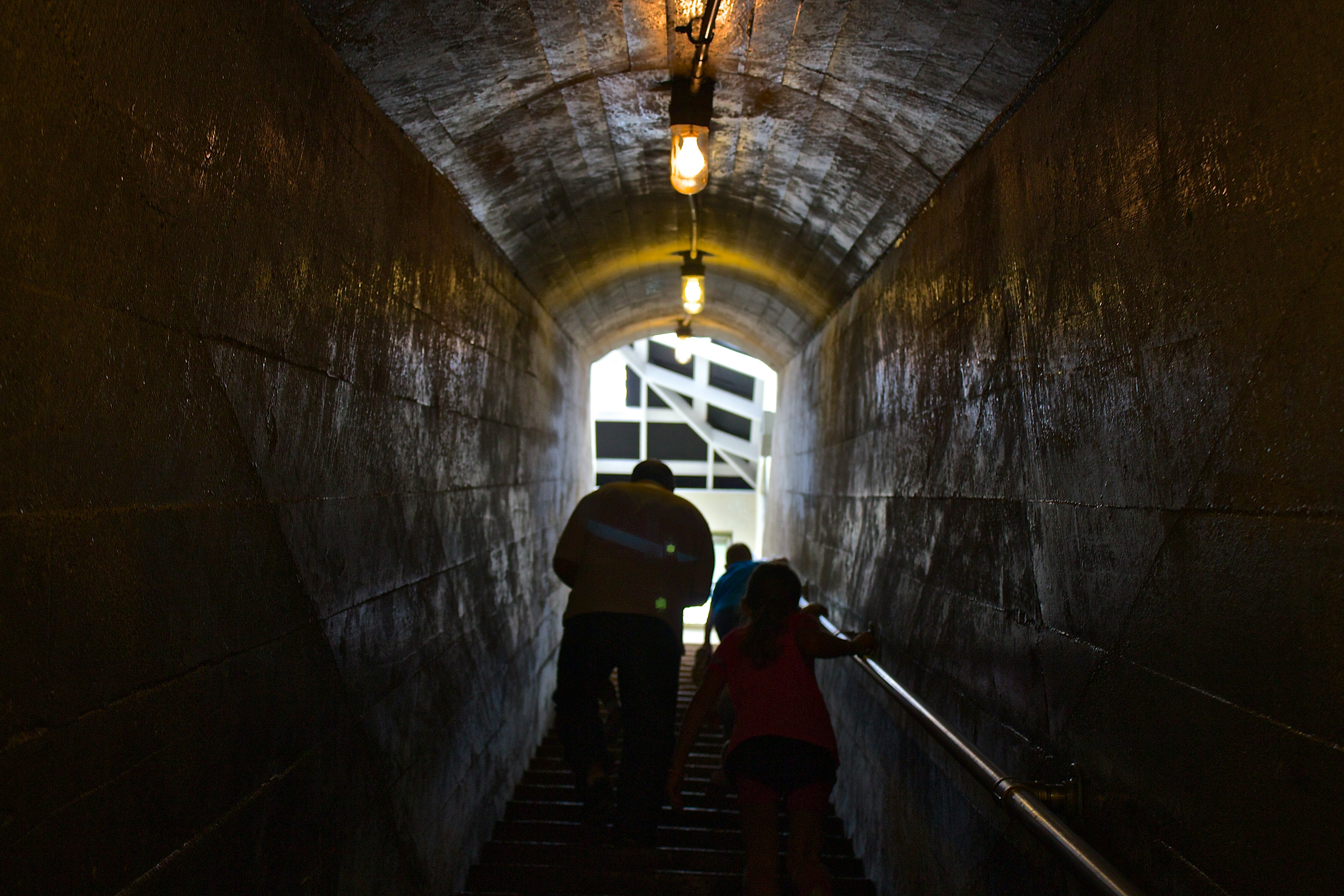 man and child passing through tunnel