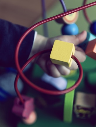 selective focus photo of baby playing activity cube