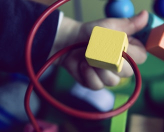 selective focus photo of baby playing activity cube