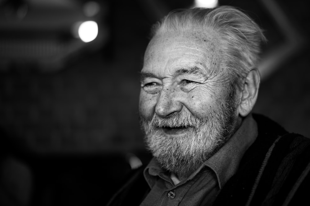 grayscale photography of man wearing button-up collared shirt