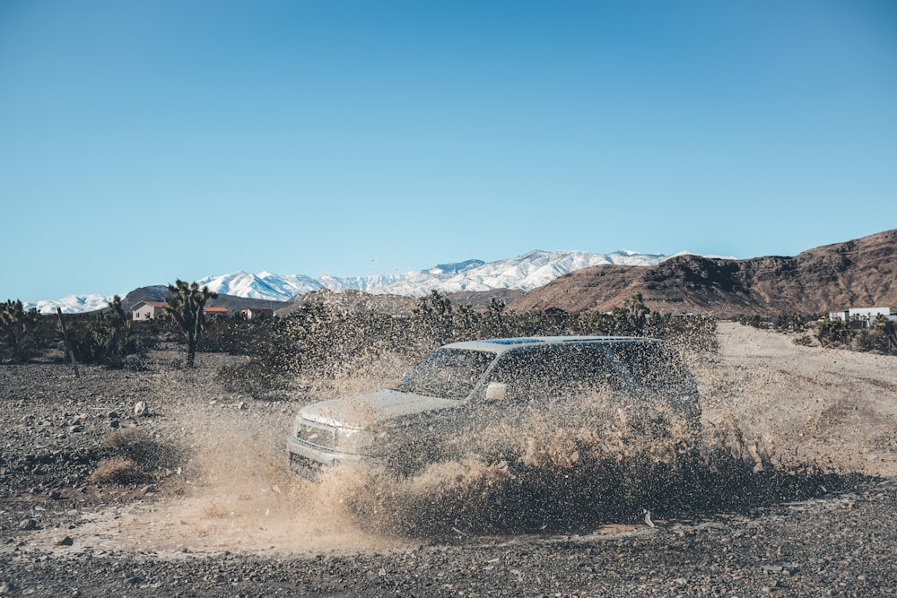 white SUV on brown field during daytime