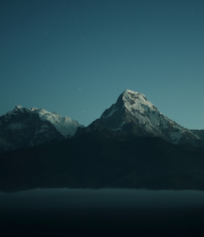 silhouette of mountains during nigh time photography