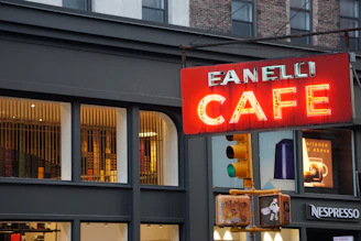 A sleek, modern sign mounted above a trendy cafe entrance
