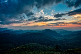A stunning landscape photograph showcasing rolling hills at sunset.