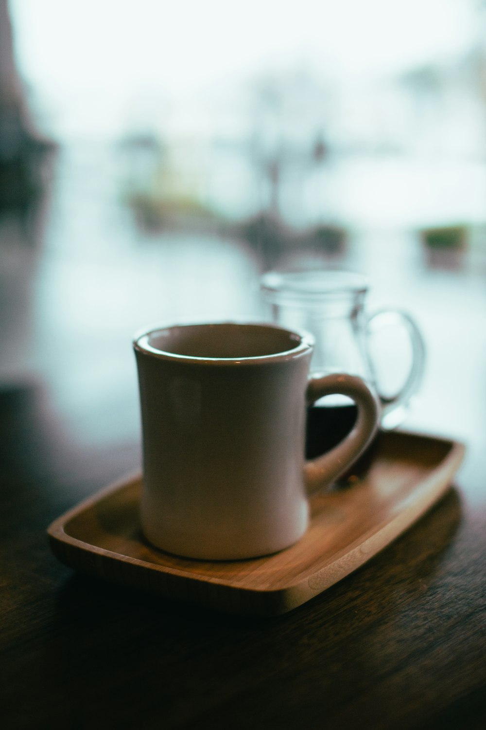 beige mug on top of brown wooden tray