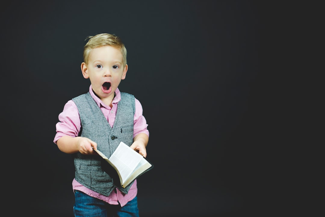 A young boy holding a book.