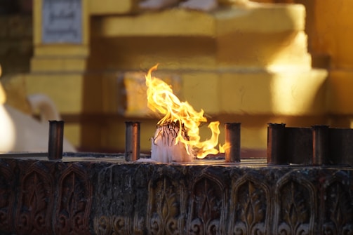 A vibrant studio shot of musicians playing sacred instruments surrounded by warm candlelight.