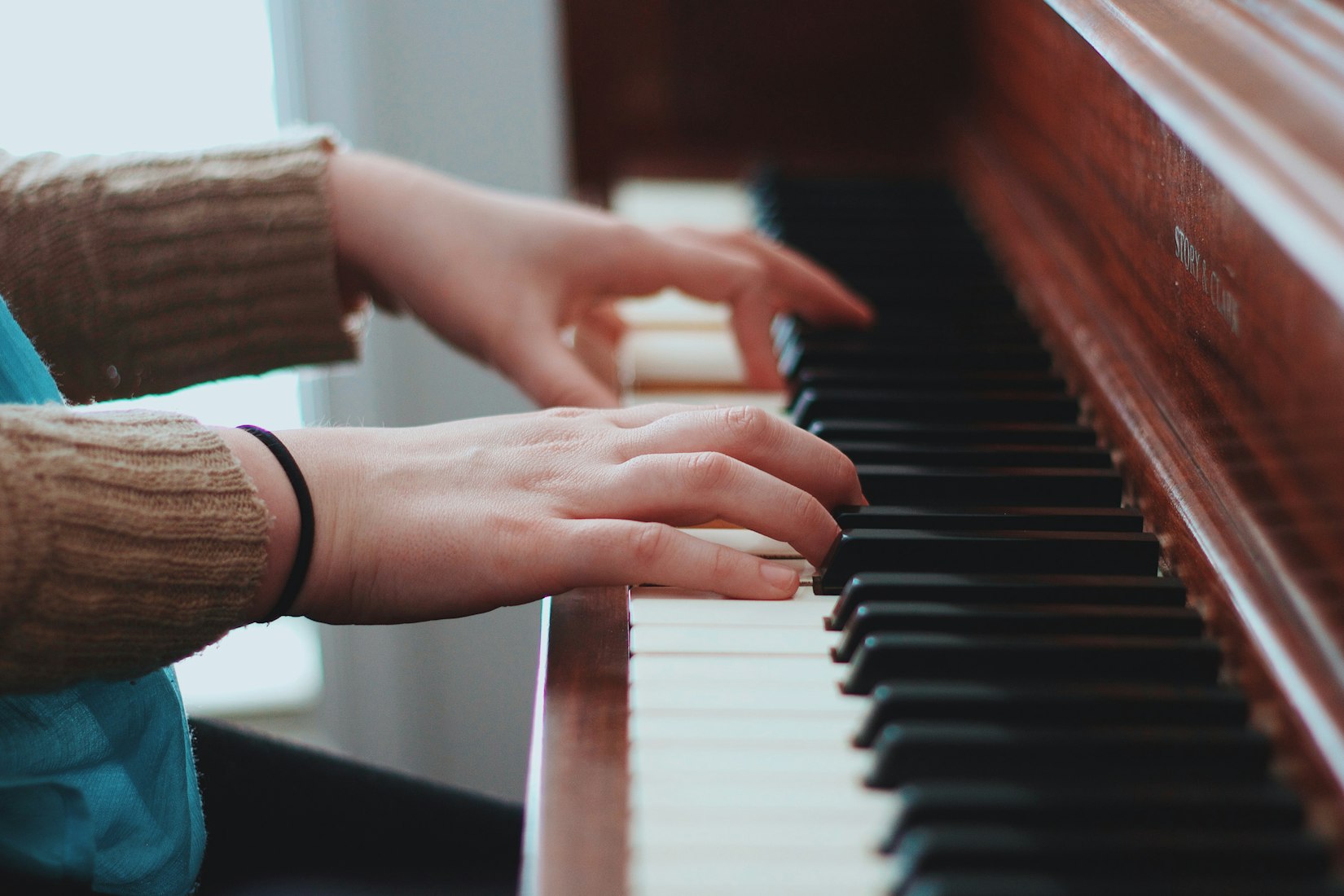 Hands playing piano