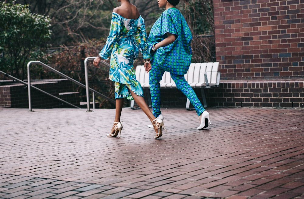 two women in teal romper pants