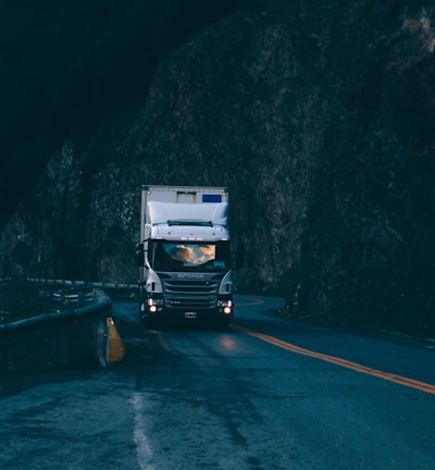 trailer truck passing on road near rail guard