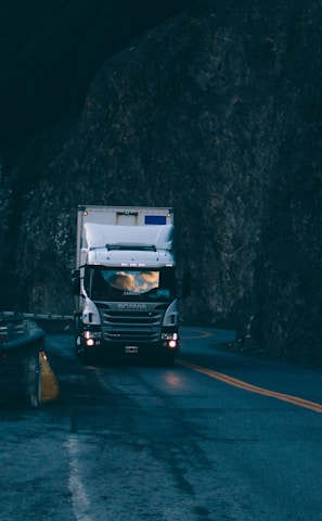 trailer truck passing on road near rail guard