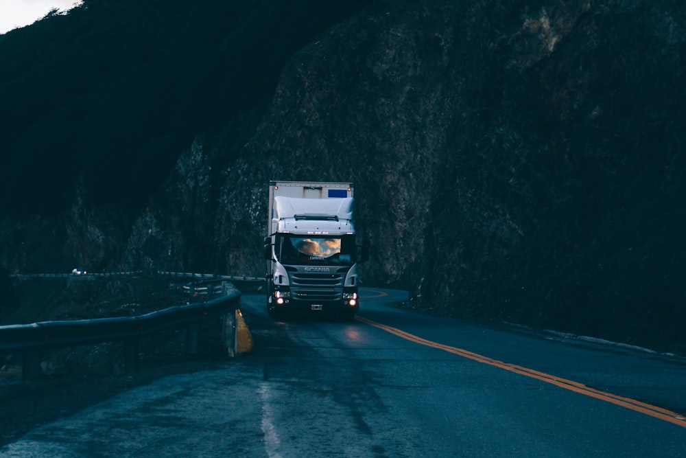 trailer truck passing on road near rail guard