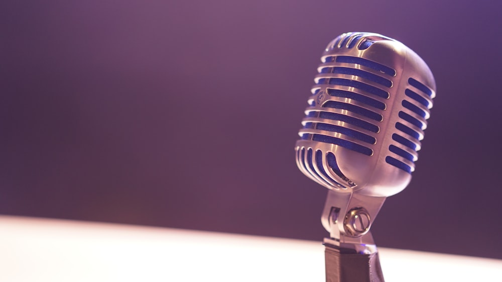 A microphone against a blurry background of white and black