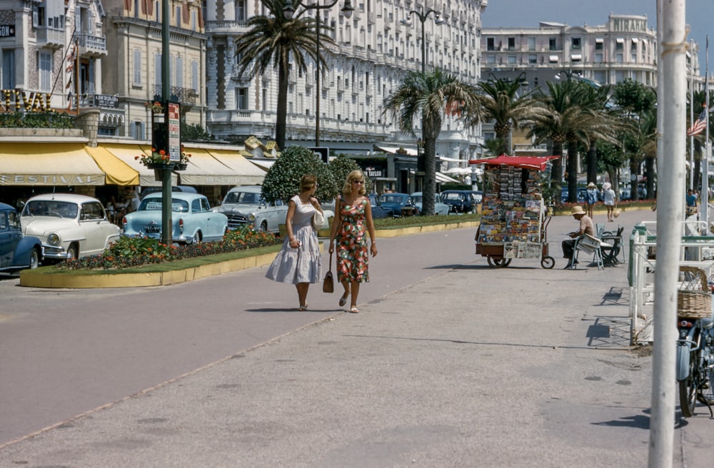 two woman walking on side walks