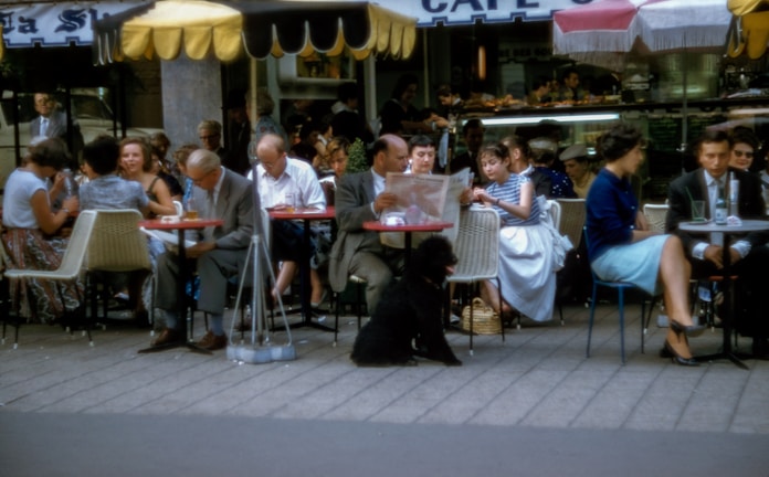 A vibrant scene of characters discussing current events in a café.