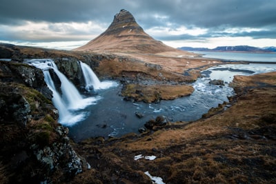 rock formation surrounded with water iceland teams background