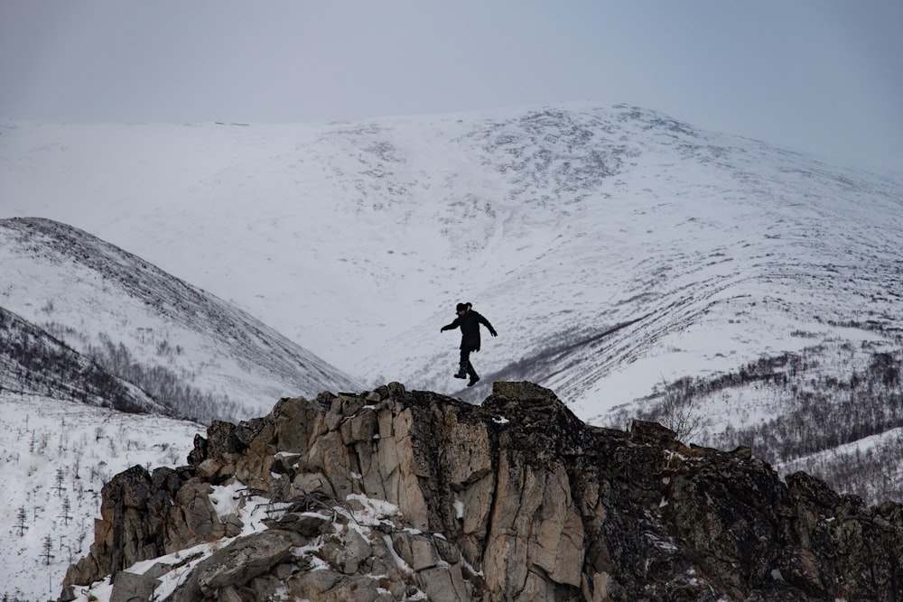 man climbing mountain of snow