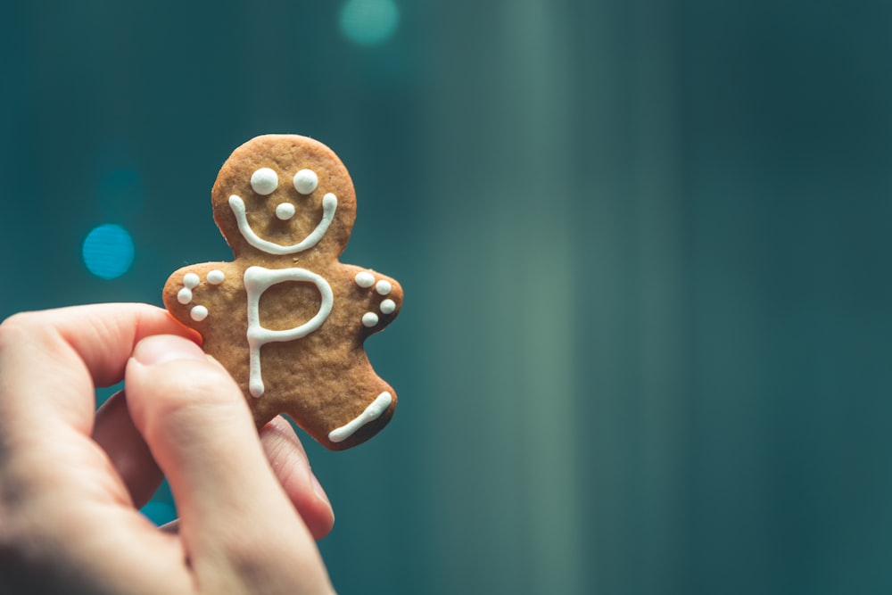 person holding brown cookie