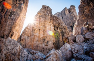 low-angle photography of brown rocky mountain under blue sky at daytime